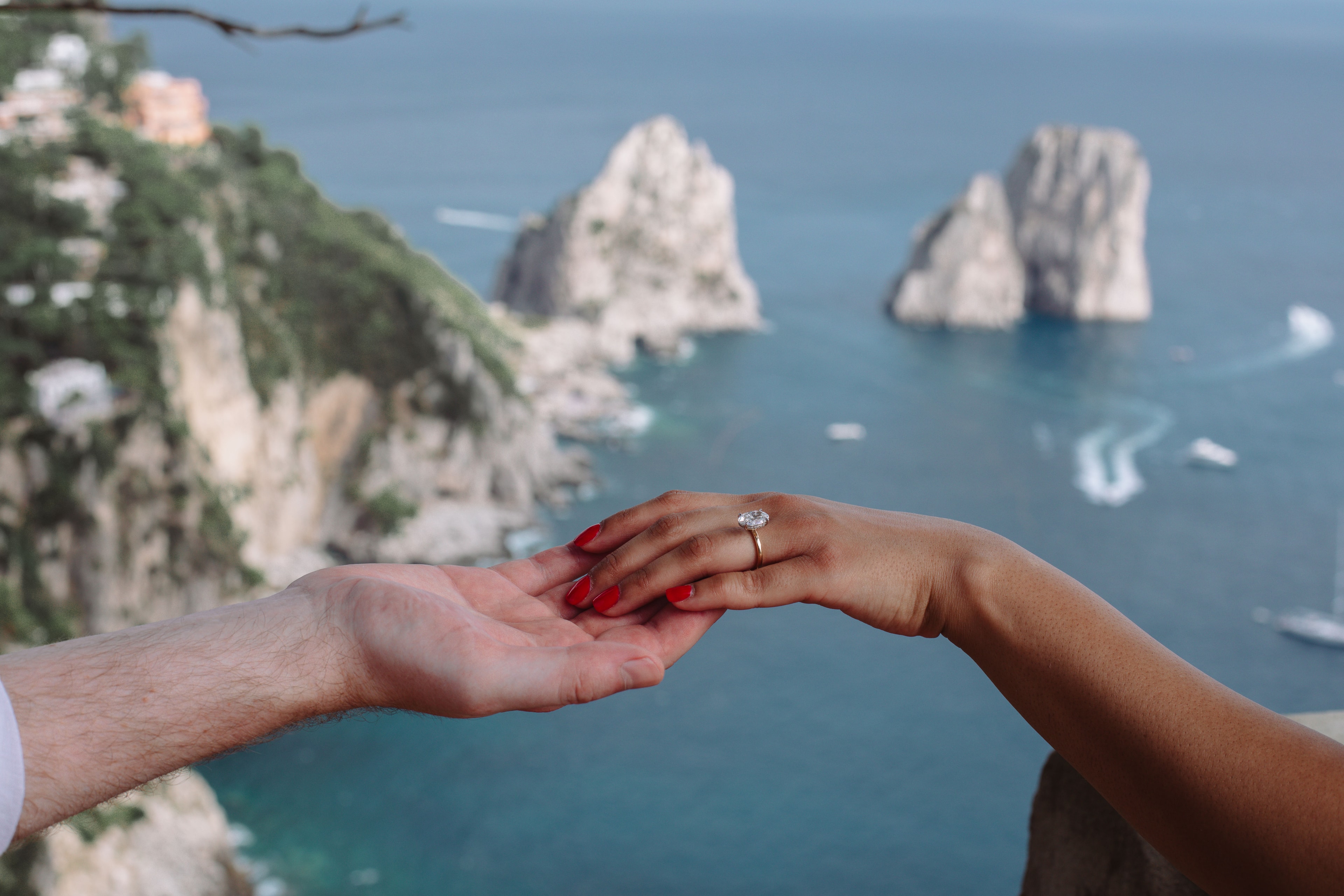 Saba's engagement ring with the Capri coastline behind